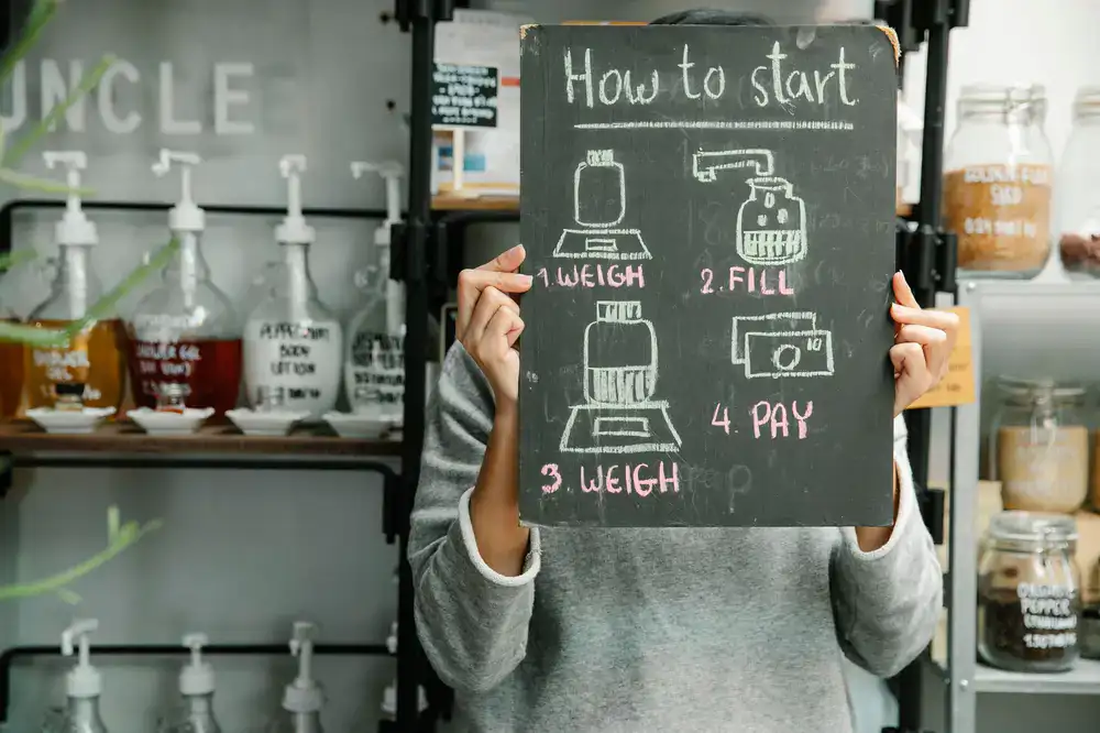 Customer weighing glass jars on a digital scale in the refill shop