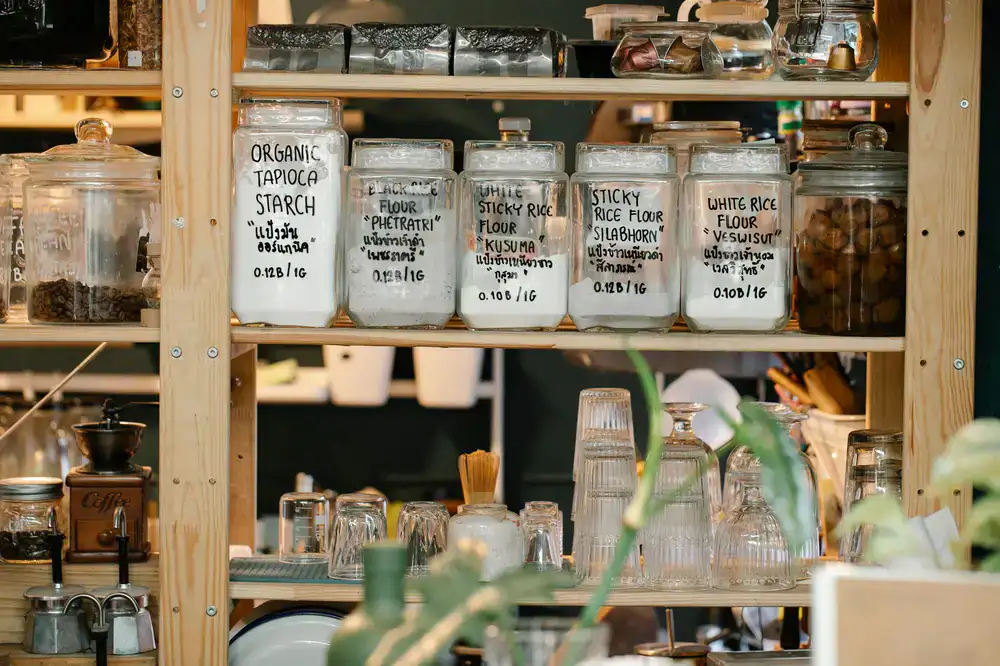 Bright shelves lined with large glass jars and wooden scoops