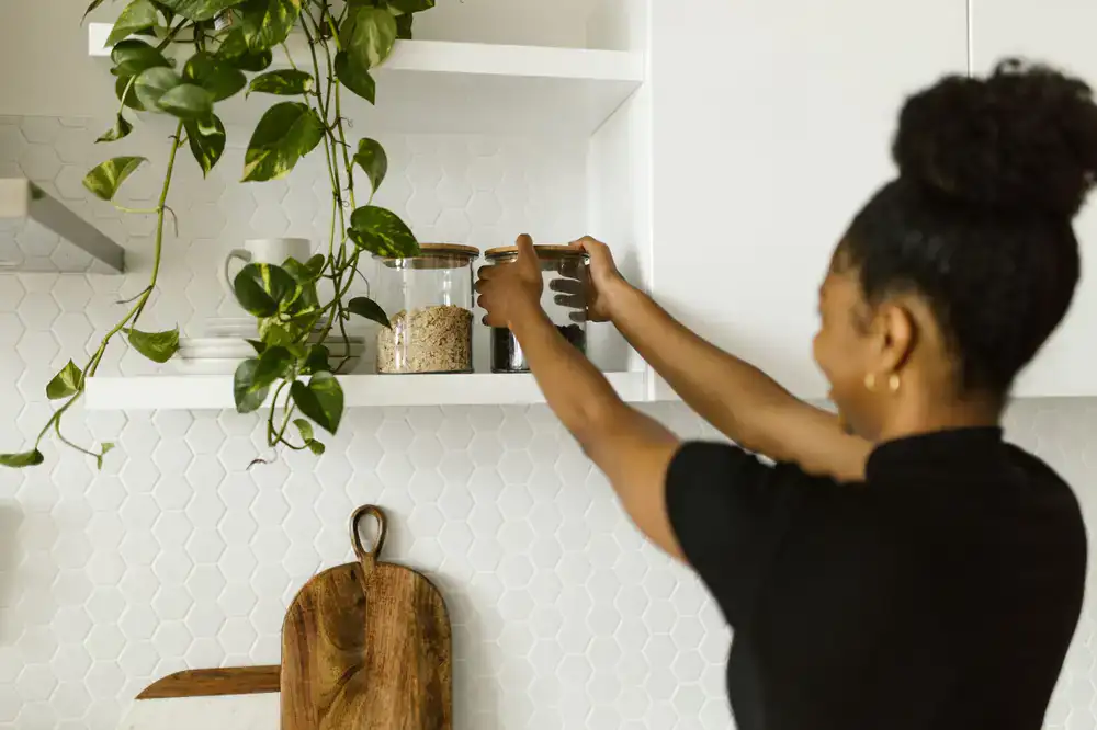 Wooden shelves neatly filled with glass jars containing dry goods